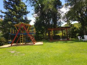a playground in a yard with a gazebo at Residencial Pousada do Serrano in Gramado