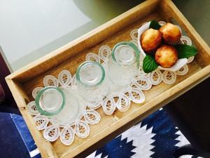 a wooden tray with glasses and a plate of food at Family Secrets Douro in Riba Douro
