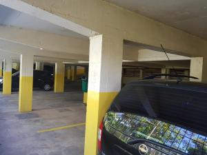 a parking lot with a car parked in it at Residencial Pousada do Serrano in Gramado