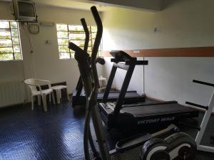 a room with a gym with a treadmill at Residencial Pousada do Serrano in Gramado