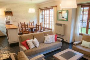 a living room with a couch and a table at Cabañas Woodland in San Martín de los Andes