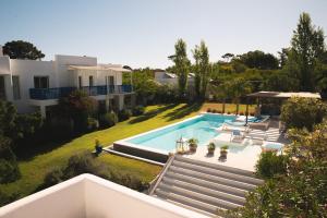 an aerial view of a house with a swimming pool at Kalá Hotel Boutique in Punta del Este