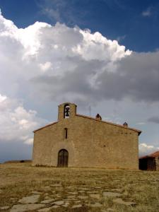 an old brick building in a field with a cloudy sky at Casa Folch in Castellfort