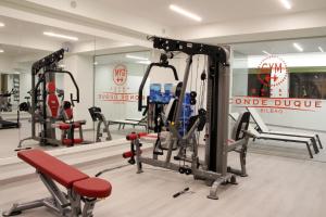 a gym with several tread machines in a room at Hotel Conde Duque Bilbao in Bilbao