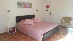 BédarridesにあるEs Aquiのベッドルーム1室(ピンクのシーツとピンクの枕が備わるベッド1台付)