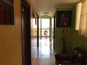 a hallway with a living room with green walls at Hostal VIYAJE in Funza