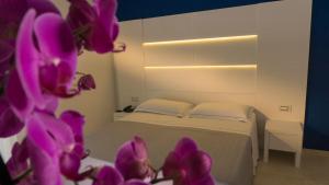 Tempat tidur dalam kamar di Hotel Scialara