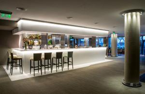 a bar in a building with stools around it at Windsor Hotel in Córdoba