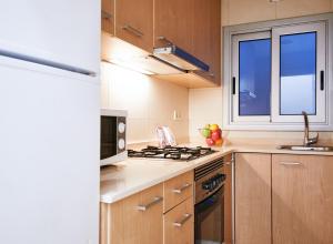 a kitchen with a stove top oven next to a window at Alcam Valencia II in Barcelona