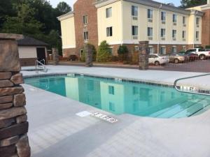 a swimming pool in front of a building at Stonebrook Lodge in Cherokee