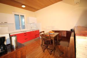 a kitchen with a wooden table and red cabinets at Makarska city center1 willa in Makarska