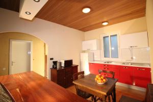 a kitchen with a table with a bowl of fruit on it at Makarska city center1 willa in Makarska +9 photos