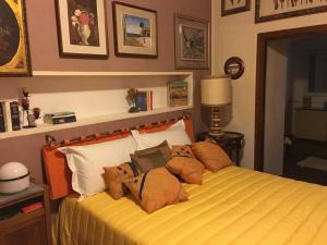 a bedroom with a bed with pillows on it at L'angolo antico in Oristano