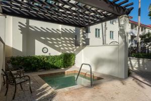a patio with a swimming pool and a pergola at Bellasera Resort in Naples