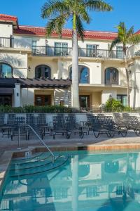 a hotel with a swimming pool in front of a building at Bellasera Resort in Naples