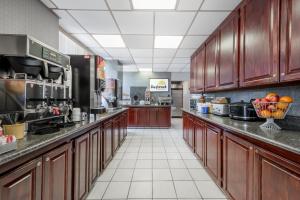 a large kitchen with wooden cabinets and appliances at Days Inn by Wyndham Amarillo East in Amarillo