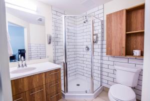 a bathroom with a shower and a toilet and a sink at United College in Waterloo