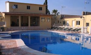 a large swimming pool in front of a house at Casa Robion in Godelleta