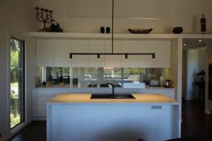a kitchen with a kitchen island with a sink at Lorne Holiday House in Lorne