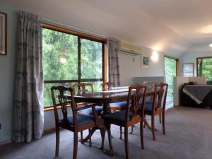 a dining room with a table and chairs and a window at Riverstone House in Geraldine