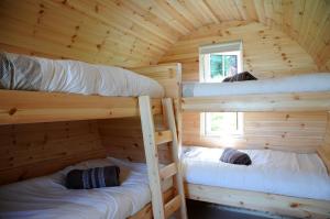 A bed or beds in a room at Coach Field Camp