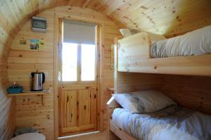 A bed or beds in a room at Coach Field Camp