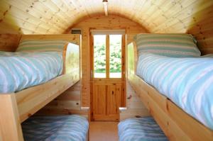 A bed or beds in a room at Coach Field Camp