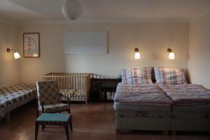 a bedroom with a bed and a chair and a crib at Country house - Slapy/Pazderny in Žďár