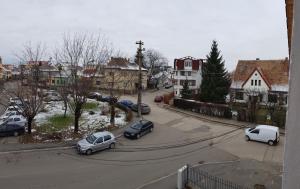 a city street with cars parked in a parking lot at Floare de Colț in Sibiu