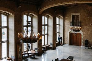 a man standing in a large room with windows at Fairmont Banff Springs in Banff