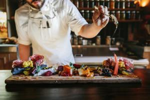 a chef is preparing food on a cutting board at Fairmont Banff Springs in Banff