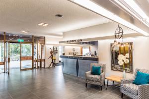 a lobby with chairs and a reception desk at Heartland Hotel Haast in Haast