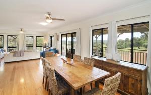 a dining room with a wooden table and chairs at Tranquility in Yallingup