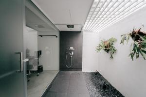a bathroom with a urinal and flowers on the wall at Lloyd's Inn in Singapore +35 photos