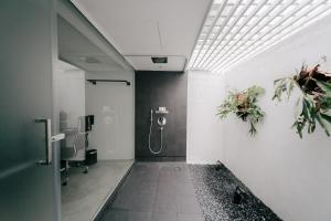 
a bathroom with a shower and a walk in shower at Lloyd's Inn (SG Clean, Staycation Approved) in Singapore
