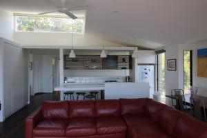 a living room with a red couch in a kitchen at Seaview Lorne in Lorne