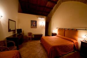 Posteľ alebo postele v izbe v ubytovaní Baglio Cudia Resort