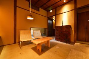 a room with a wooden table and two chairs at Kuraya Kiyomizu Gojo in Kyoto