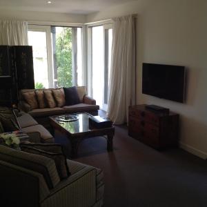 a living room with a couch and a coffee table at Lorne Holiday House in Lorne
