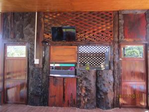 a room with two doors and a tv on the wall at Maan Mork Khao Kho in Khao Kho