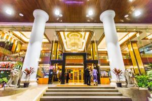 Town in Town Hotel Bangkok - SHA Plus في بانكوك: مجموعة اشخاص واقفين امام مول تجاري