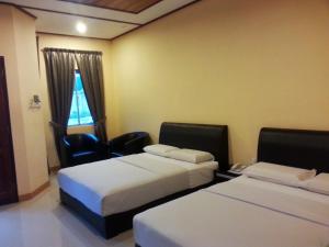 New Dawn for Langkawi tesisinde bir odada yatak veya yataklar