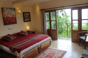 a bedroom with a bed and a sliding glass door at Rangala House in Digana