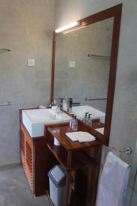 a bathroom with a sink and a mirror at Rangala House in Digana