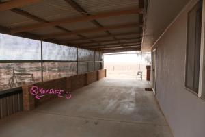 a room with a door open to a patio area at Breakaway Views 374 ALP ST in Coober Pedy