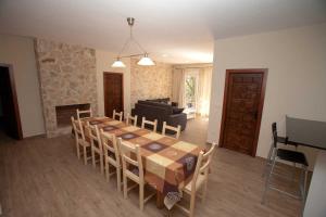 a dining room with a table and chairs and a fireplace at Casa rural la forilla in Ruidera
