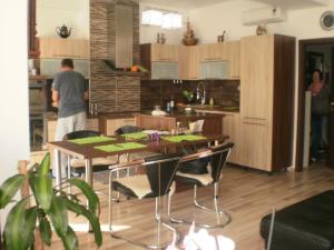 a man in a kitchen with a table and chairs at AKI - 2 +KK in Brno