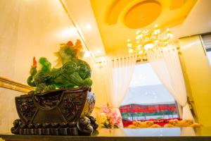 a vase sitting on a table next to a window at Sen Motel in Bien Hoa