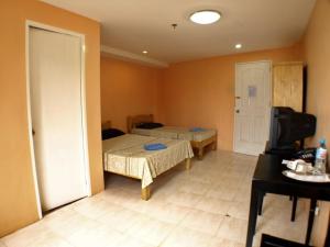 Postel nebo postele na pokoji v ubytování Lylie Hotel