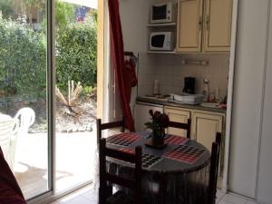 eine Küche mit einem Tisch und eine Küche mit einer offenen Tür in der Unterkunft 4SAP7 Appartement avec belle terrasse in Collioure